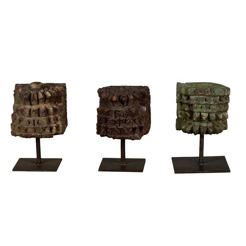 Carved Wooden Pillar Capital Fragments on Iron Stands by Studio Vastu